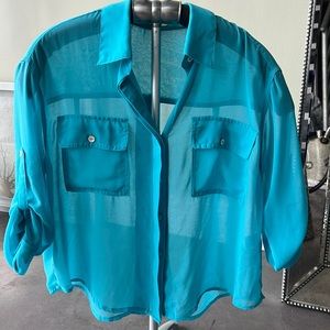 Fun electric blue boxy blouse. Wear over a high pencil skirt or boxy trousers.